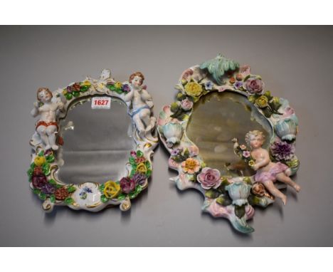 A Continental porcelain wall mirror, decorated cherub and encrusted flowers, 31cm; together with another similar easel back e