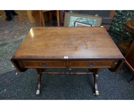 A reproduction inlaid mahogany sofa table, 91cm wide when closed, 145cm when open.Payment must be made in advance of collecti