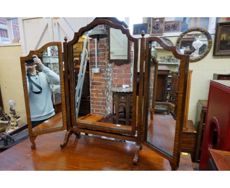 A 1930s walnut triptych mirror, 68.5cm wide; together with another similar easel back example, 58.5cm high. (2) 