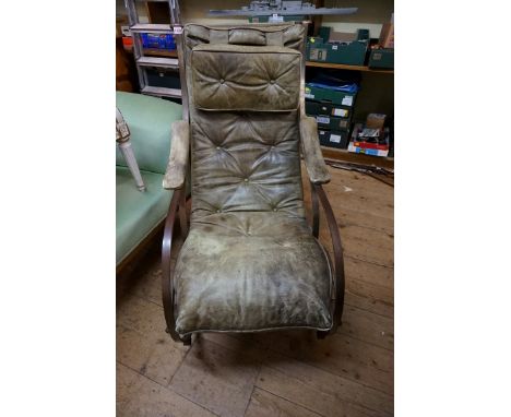 A reproduction R W Winfield steel and green leather rocking chair.&nbsp;