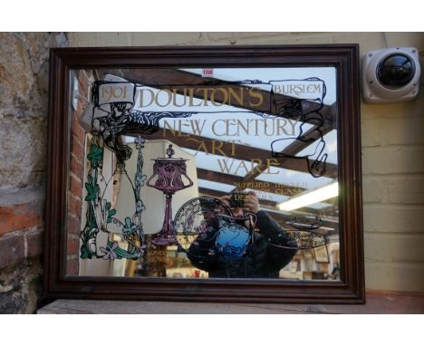 An advertising mirror, inscribed 'Doulton's New Century Art Ware', framed, the whole 65 x 81cm.&nbsp;&nbsp; 