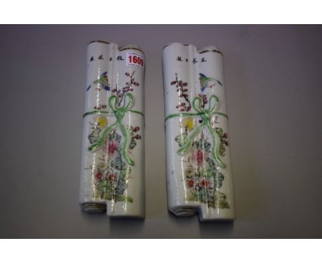 A pair of Chinese famille rose wall pockets,&nbsp;each in the form of a tied scroll, 23cm long. 