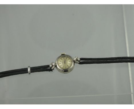 A LADY'S ART DECO 18CT WHITE GOLD DIAMOND 'JUVENIA' COCKTAIL WATCH. The champagne coloured dial having white gold baton numer