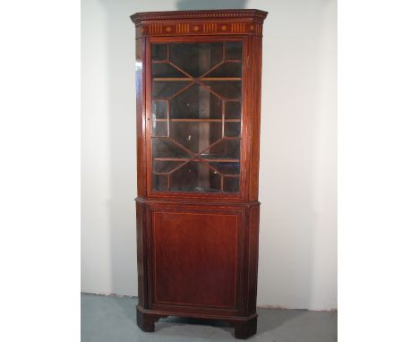 EDWARDIAN INLAID MAHOGANY DOUBLE CORNER CABINET having satinwood inlaid and moulded frieze over astragal glazed door with thr