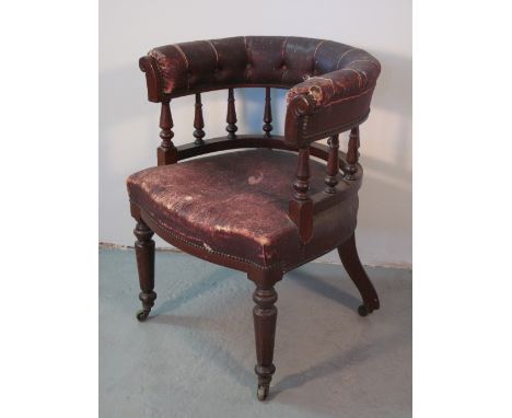 VICTORIAN MAHOGANY UPHOLSTERED TUB SHAPED LIBRARY OR DESK CHAIR having padded back over baluster turned spindles, serpentine 