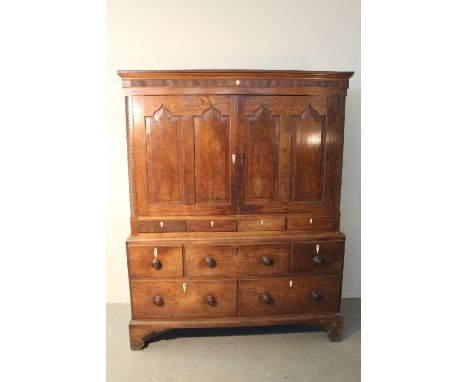 EARLY 19TH CENTURY WELSH OAK LOW TWO STAGE PRESS CUPBOARD having moulded cornice over reeded frieze with heart shaped escutch