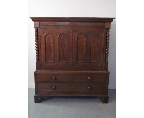 19TH CENTURY WELSH OAK LOW PRESS CUPBOARD having moulded cornice over a pair of double arch panelled doors flanked by bobbin 