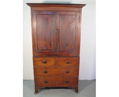 18TH CENTURY STAINED PINE TWO SECTION PRESS CUPBOARD having moulded and reeded cornice over two blind panel doors with fitted