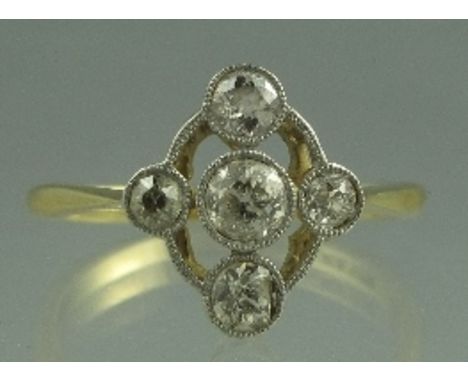 AN EDWARDIAN 18CT GOLD FIVE STONE DIAMOND RING. The old cut diamonds milligrain set in a cross design. Ring size Q.  CONDITIO