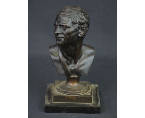 AFTER THE ANTIQUE, PATINATED BRONZE PORTRAIT BUST OF A ROMAN MAN, on formerly gilded soccal base and black slate plinth. Over