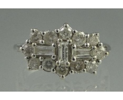 AN 18CT WHITE GOLD AND DIAMOND RECTANGULAR CLUSTER RING of three baguette cut and twelve brilliant cut diamonds. Estimated to