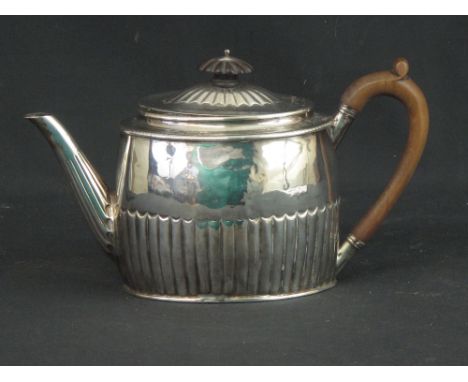 LATE 18TH CENTURY SILVER HALF FLUTED OVAL TEAPOT with wooden handle and finial. London, 1792, makers mark HG. 14.5 troy ounce