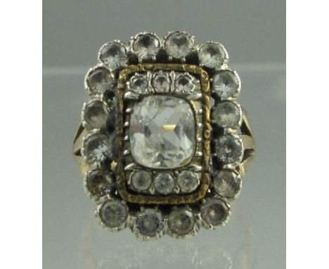 AN EARLY VICTORIAN DRESS RING of rectangular form set with white stones in a yellow metal mount. Tests as 15ct. Ring size T1/