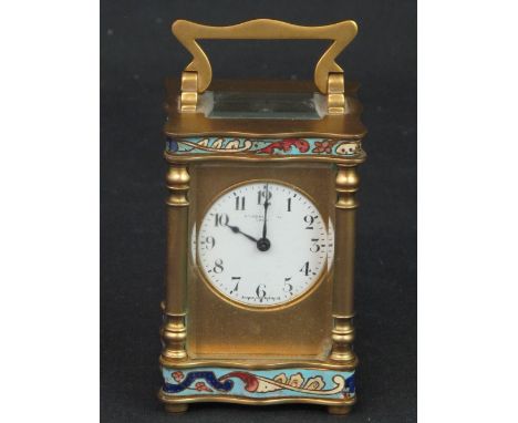 SMALL FRENCH BRASS AND CHAMPLEVE ENAMEL CARRIAGE TYPE MANTLE CLOCK having gorge case with folding handing, column corners, ci