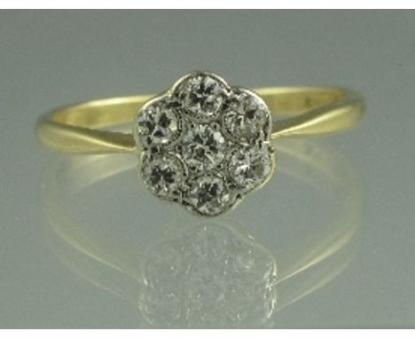 AN 18CT GOLD FIVE STONE DIAMOND CLUSTER RING. The old cut stones in milligrain flower head mount. Ring size Q.  CONDITION REP