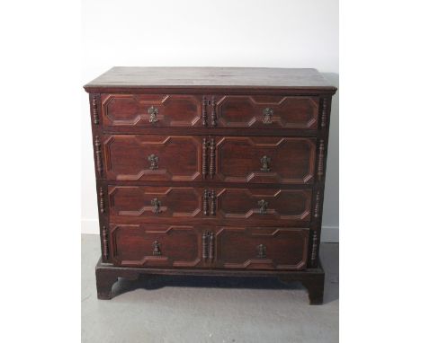 17TH CENTURY STYLE OAK STRAIGHT FRONTED CHEST of four graduated drawers, in two sections under a framed moulded top, the draw
