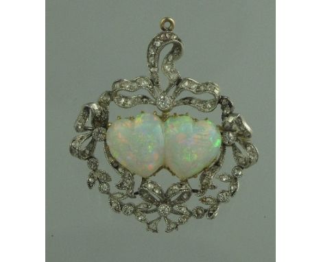 A VICTORIAN OPAL AND DIAMOND DOUBLE HEART BROOCH. The single double heart shaped opal set within a border of diamond set ribb