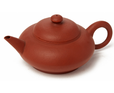 A SMALL COMPRESSED CIRCULAR YIXING POTTERY TEAPOT Impressed seal mark to base 12cm long / 100g
Condition: One small chip to t