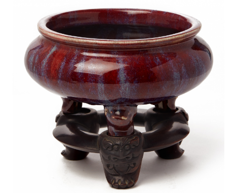 A FLAMBÉ GLAZED TRIPOD CENSER On carved wood stand 20cm high including stand / 3.1kgs
Condition Minor scratches to the interi