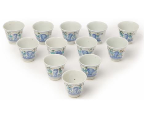 A SET OF TWELVE WUCAI PORCELAIN WINE CUPS Guangxu six character mark in underglaze blue to base Decorated with rocks and flow