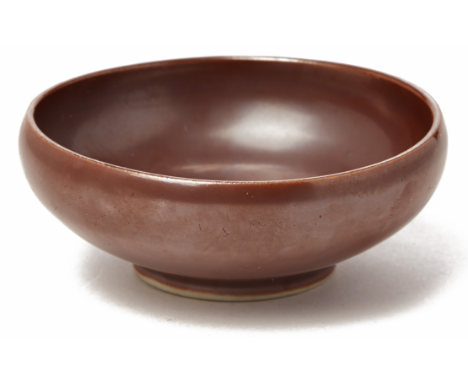 A MAROON PORCELAIN BOWL WITH ROUNDED EDGES 18th century, according to the inventory With a rustic chocolate glaze with a unif