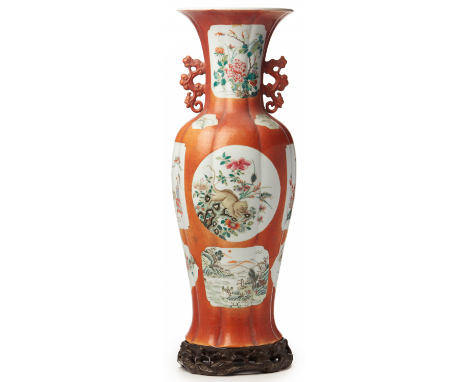 A LARGE CORAL GROUND BALUSTER PORCELAIN VASE Qianlong iron red seal mark to base Decorated with famille rose panels 70cm high