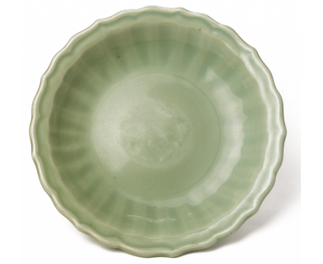 A LONGQUAN CELADON CHARGER Ming dynasty, according to the inventory with fluted border and barbed rim 31cm diameter, 2kg Prov