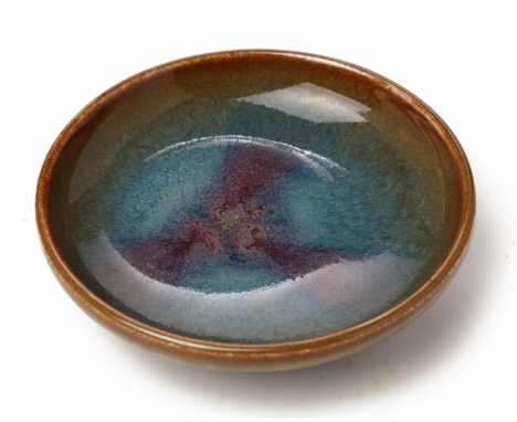 A JUN WARE CIRCULAR SHALLOW DISH With typical blue and purple glaze, unglazed base 14cm diameter / 330g
Condition; Minor crac