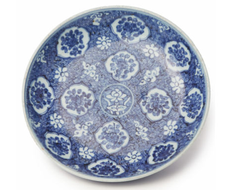 A BLUE AND WHITE PORCELAIN CHARGER (1) Decorated with shaped reserves of flowers on a geometric patterned ground 32cm diamete