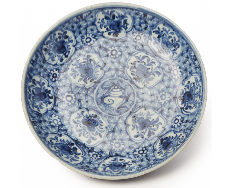 A BLUE AND WHITE PORCELAIN CHARGER Decorated with a central shell motif and shaped floral reserves on a geometric ground 32cm