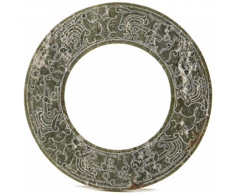 A CARVED JADE CEREMONIAL BI DISC Carved to both sides in shallow relief with mythical birds 16cm diameter 188g
______________