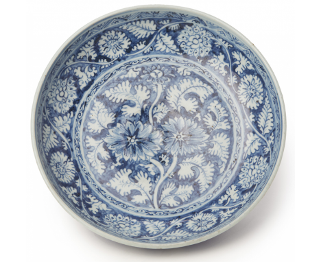 A BLUE AND WHITE PORCELAIN CHARGER (2) ecorated with scrolling flowers and foliage 32cm diameter &gt;&gt; Small chip to for r