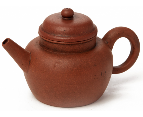 A SPHERICAL YIXING POTTERY TEAPOT Impressed seal mark to base With angular spout and domed cover 14cm long 250g
_____________