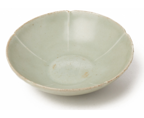 A LONGQUAN CELADON LOBED DISH Northern Song With notched rim, the centre impressed with four character seal 15cm diameter Wit