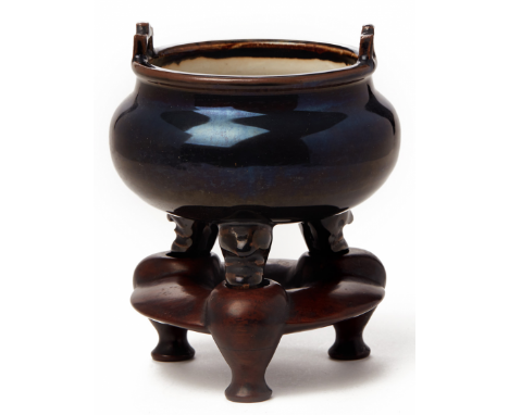 A BLACK GLAZED PORCELAIN TRIPOD CENSER 18th century, according to collector's inventory With twin handles and high gloss blac