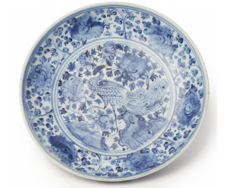 A BLUE AND WHITE PORCELAIN 'PEACOCK' CHARGER Decorated with a central peacock amongst flowers and foliage 32cm diameter 1.6kg