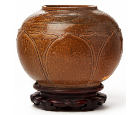 A GLOBULAR BROWN GLAZED PETAL MOULDED POTTERY JAR Circa 10th century, according to the inventory Moulded with petals and inci