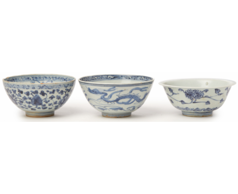 THREE BLUE AND WHITE PORCELAIN BOWLS (1) One example with a trailing dragon, the other examples with various scrolling foliag