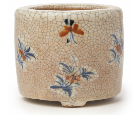 A CYLINDRICAL CRACKLE GLAZE BRUSH POT Decorated with floral sprigs, raised on three short feet 13cm / 1.1kg Provenance: Purch