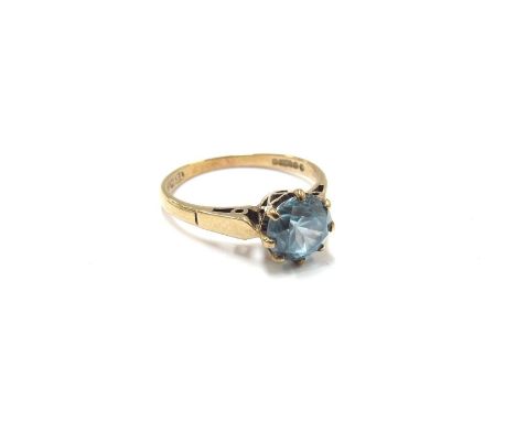 A 9ct gold ring with round cut blue Topaz. Size J/K, 1.8g 