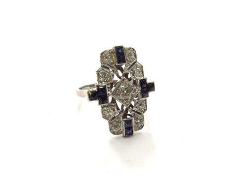 An Art Deco design ring, round cut diamond to centre in square setting with French cut sapphires to each quarter with two old