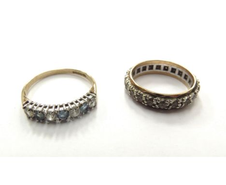 A 9ct gold eternity ring with paste stones and a 9ct gold topaz and cubic zirconia half hoop ring, 4.5g total 