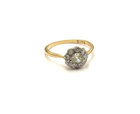 A diamond daisy cluster ring, stamped 18ct. Size P, 2.6g 