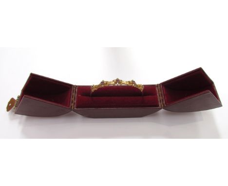 A 9ct gold bangle with raised floral motifs with amethyst stone centre framed by clear stones, 9.1g 
