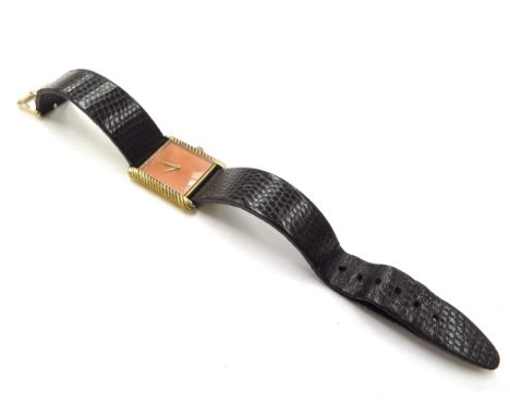Delaneau. A lady's 18K gold cased manual wind rectangular wristwatch with coral dial, cabochon on winder missing, on leather 