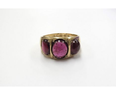 An 18ct gold three stone cabochon garnet ring (resized). Chester 1886. Size U/V, 9.8g 