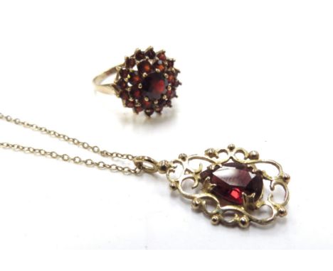 A 9ct gold chain, 48cm long hung with a 9ct gold framed pear shaped garnet pendant, 2.8g and a 9ct gold garnet cluster ring. 