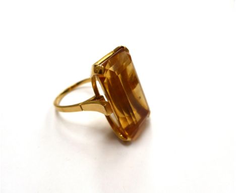 A large emerald cut citrine 2.5cm x 1.5cm ring on unmarked gold ring shank. Size U 