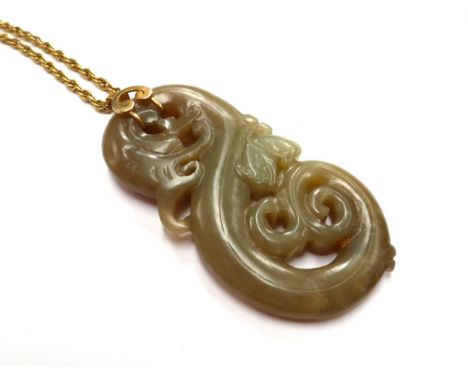 A carved Jade pendant of a dragon with bat like creature, 8cm x 4cm, hung on a gold chain stamped 18ct, 60cm long 