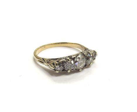 A five stone diamond ring, the five graduated old cut diamonds spaced by small old cut diamonds (3 missing), stamped 18ct. Si